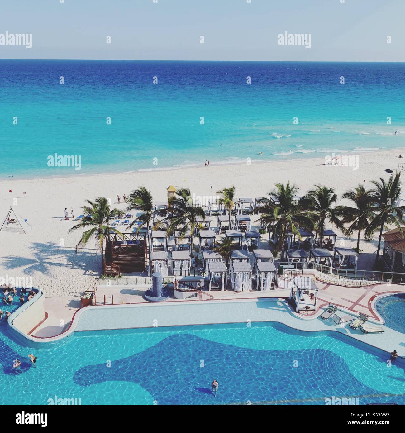 An afternoon view of the pool and beach from a balcony at the Hyatt Zilara, Cancun, Quintana Roo, Mexico - Smartphone Captured Stock Image