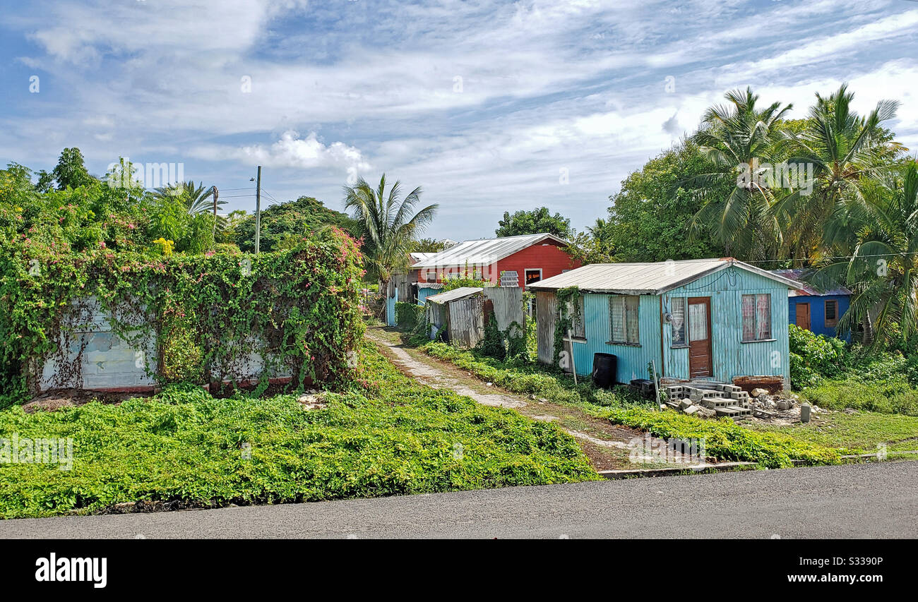 Seatons, Antigua and Barbuda, December 27, 2019:  Three colorful typical homes in Antigua Barbuda Lesser Antilles, West Indies, Caribbean. - Smartphone Captured Stock Image