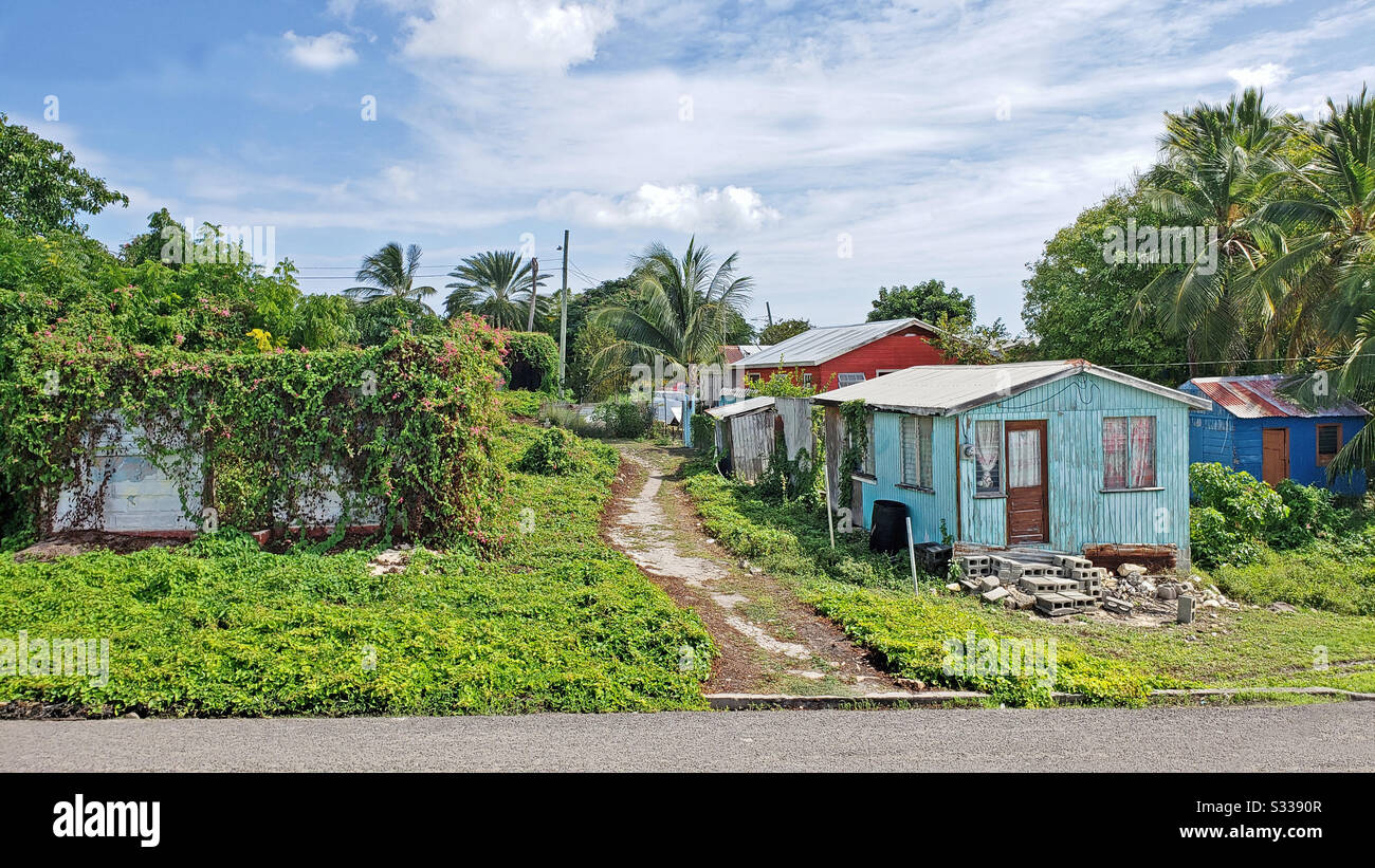 Seatons, Antigua and Barbuda, December 27, 2019:  Three colorful typical homes in Antigua Barbuda Lesser Antilles, West Indies, Caribbean. - Smartphone Captured Stock Image