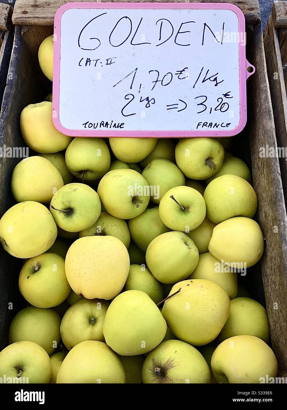 Golden Delicious apples on French market stall. Stock Photo