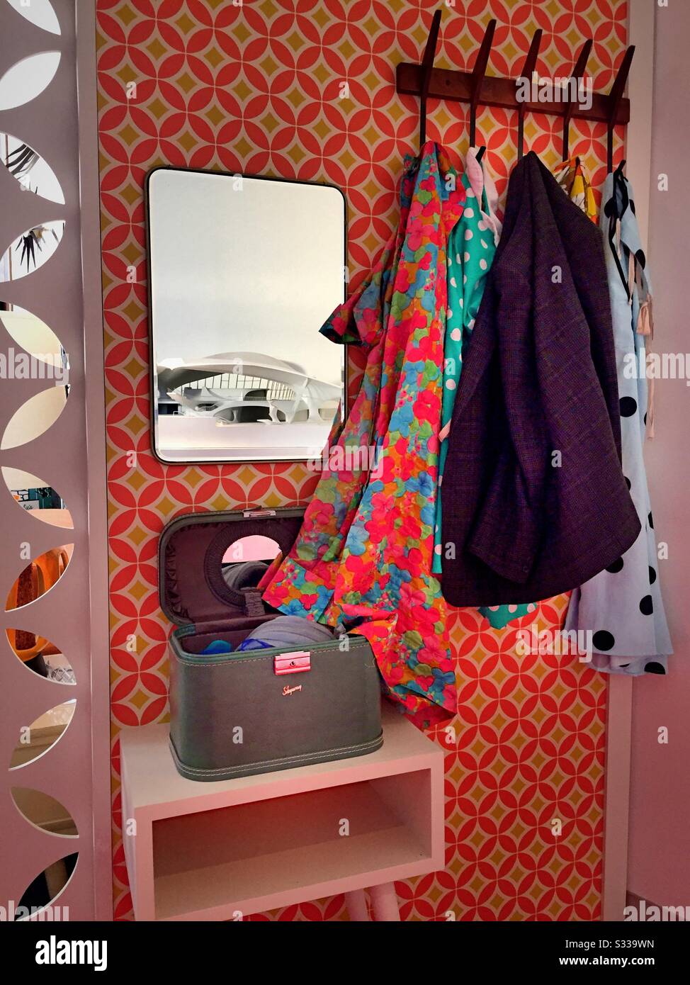 Clothes rack and mirror in the museum exhibit of a 1962 living room at the TWA Hotel at JFK airport in New York City, United States Stock Photo