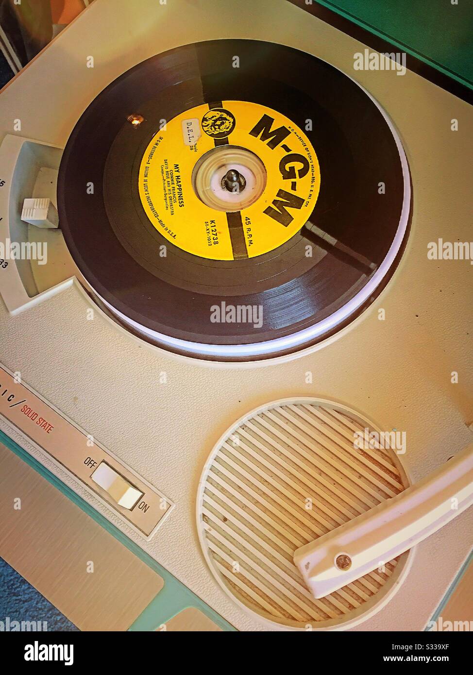 Vintage 1960s portable phonograph player and a vinyl 45 RPM record close up, USA - Smartphone Captured Stock Image