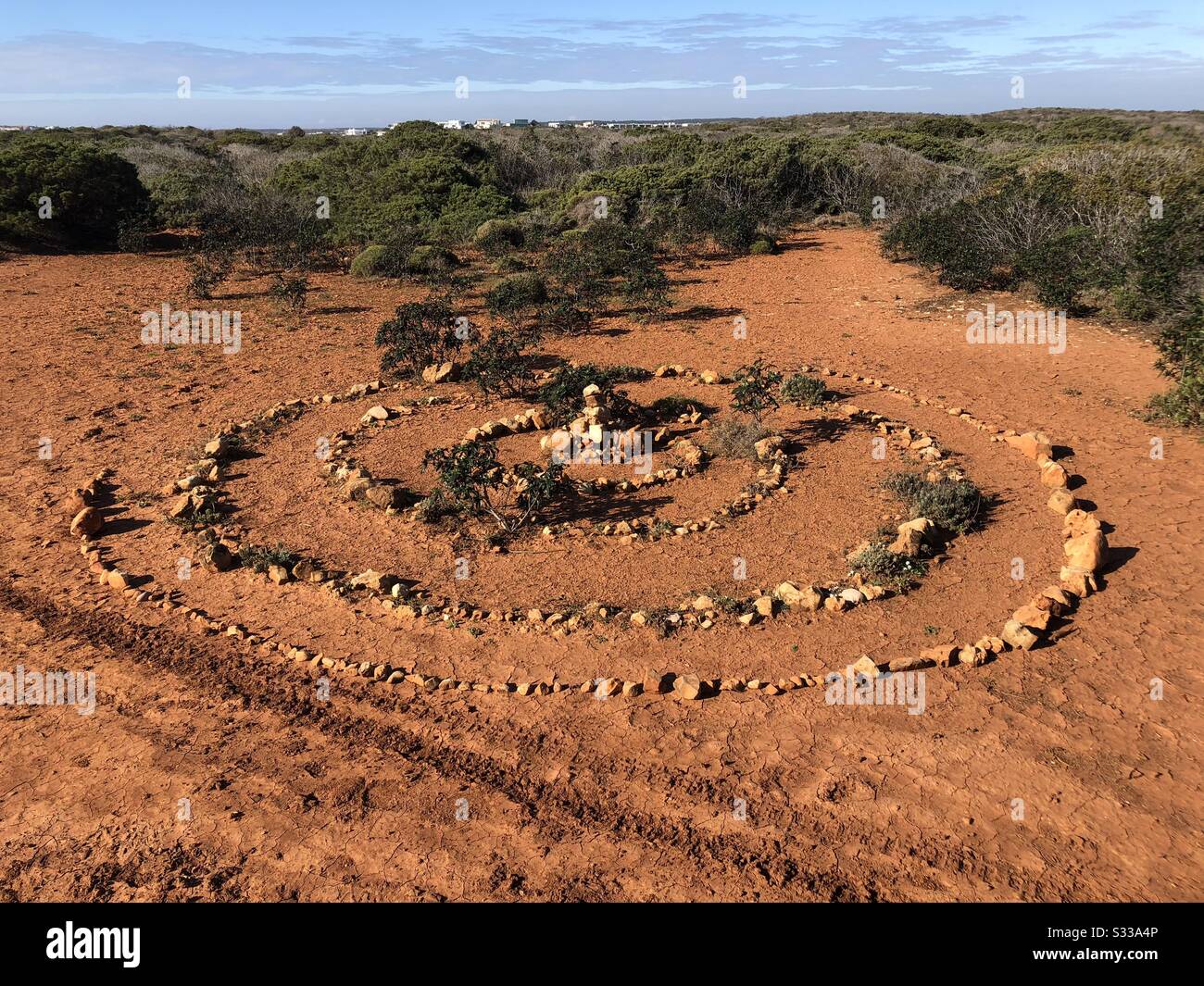 Spiral pattern made with lots of small stones placed on the ground - Smartphone Captured Stock Image