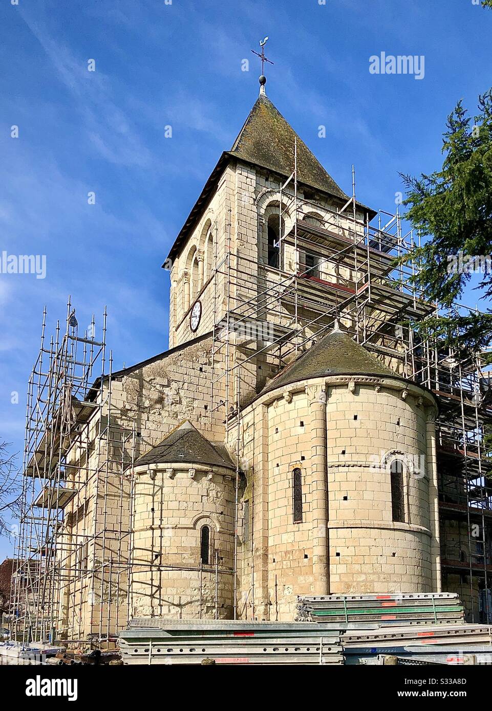 Scaffolding erected on ancient church undergoing restoration - France. - Smartphone Captured Stock Image
