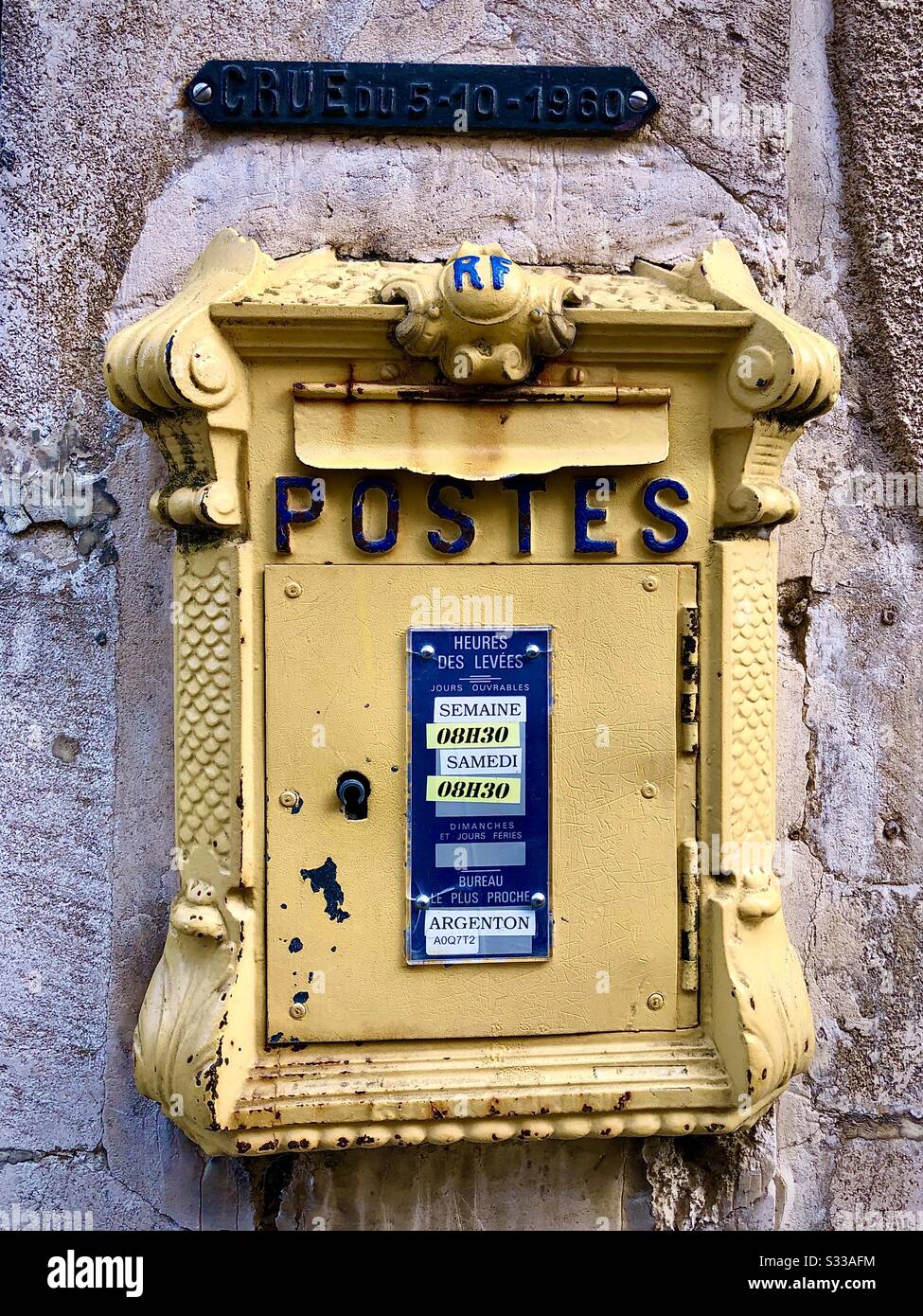 Old French letter post box with 1960 river flood level marker above - Argenton-sur-Creuse, Indre, France. - Smartphone Captured Stock Image