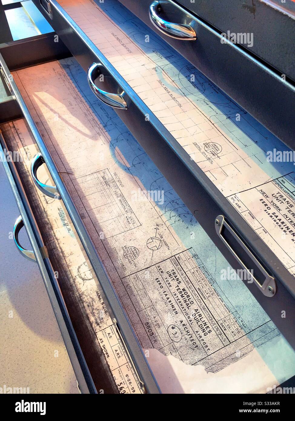 Close up of drawers in an architects cabinet filled with blueprints, TWA hotel, JFK, NYC, USA - Smartphone Captured Stock Image