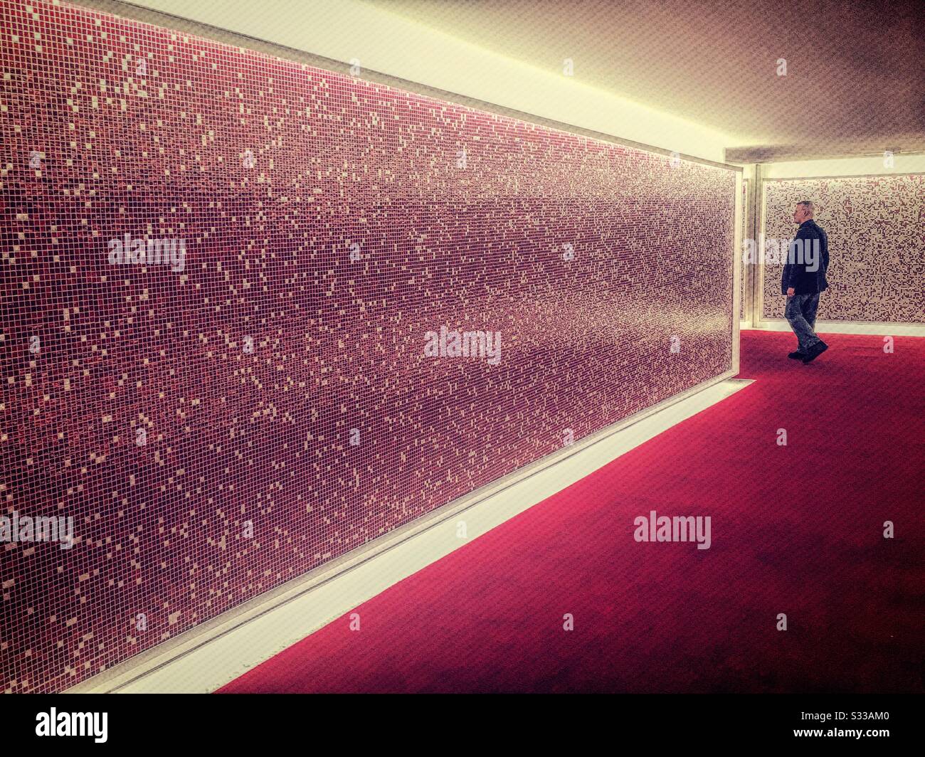 Futuristic space age lighted hallway has a chili pepper red carpet. - Smartphone Captured Stock Image
