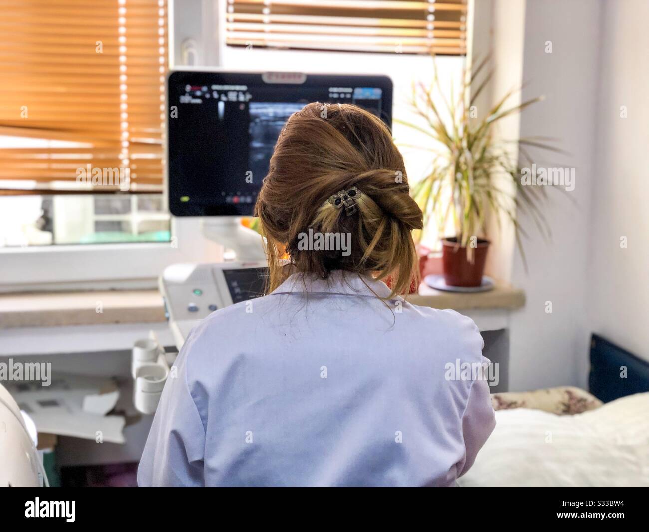 Woman doctor performing ecography - Smartphone Captured Stock Image