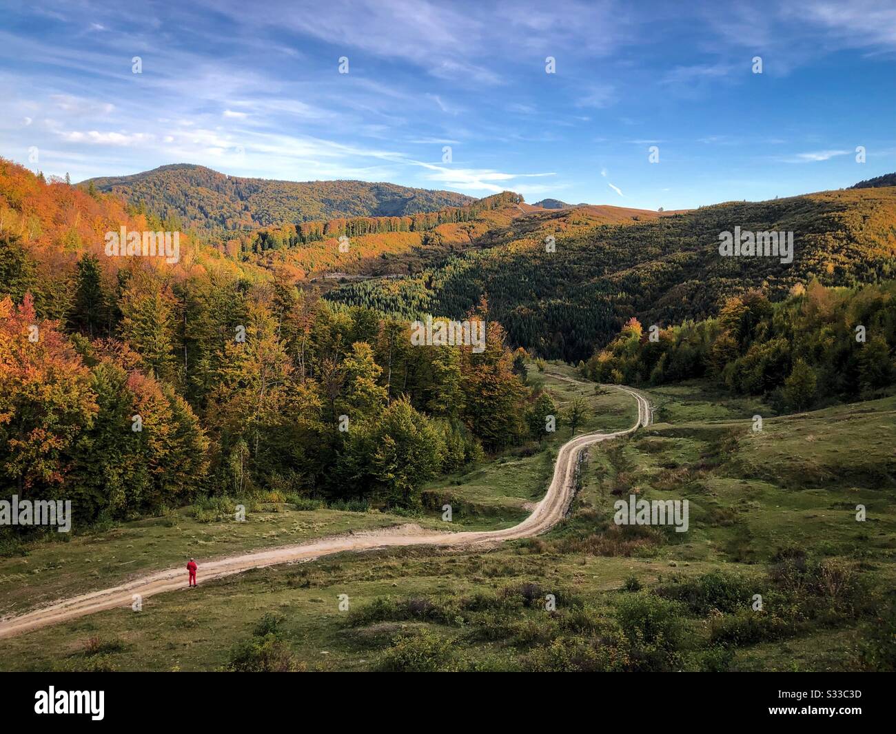Silhouette of a man on a road in the middle of the mountains - Smartphone Captured Stock Image