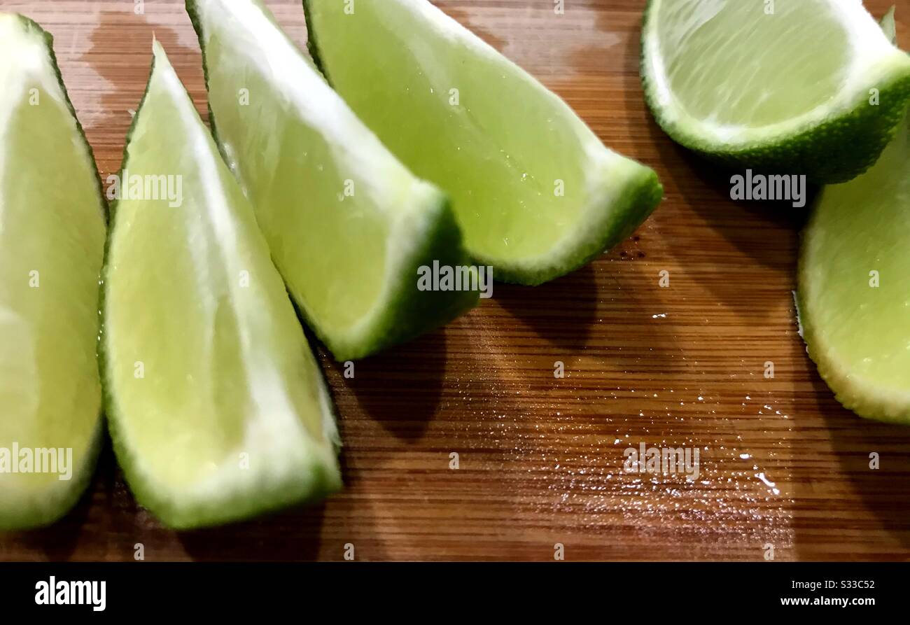 Sliced limes on a cutting board. Stock Photo