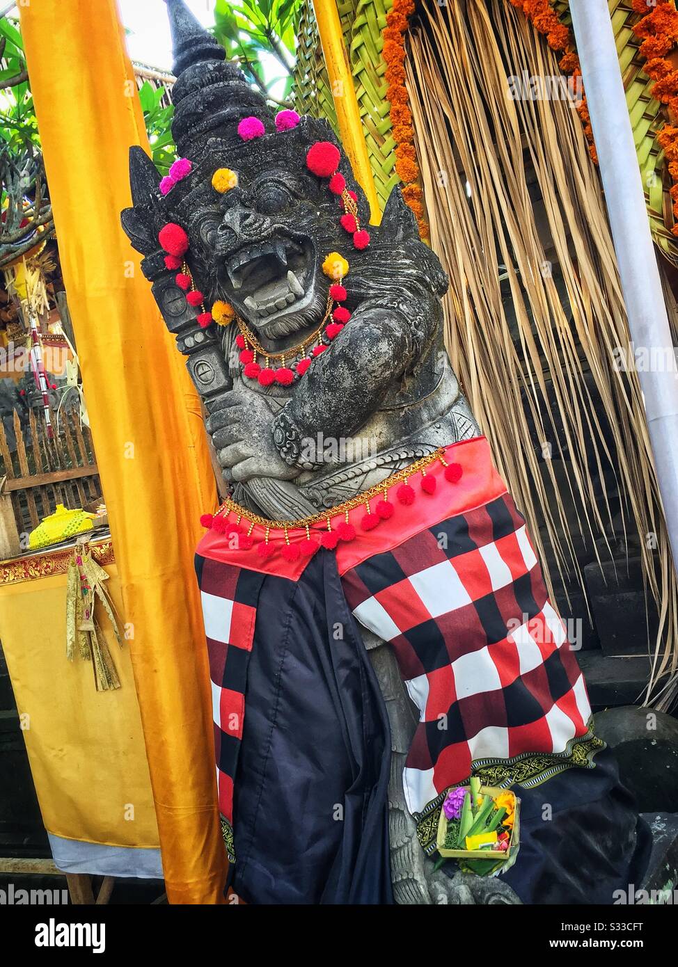 A Bedogol, or temple guardian, decorated for a religious festival in Ubud, Bali, Indonesia - Smartphone Captured Stock Image