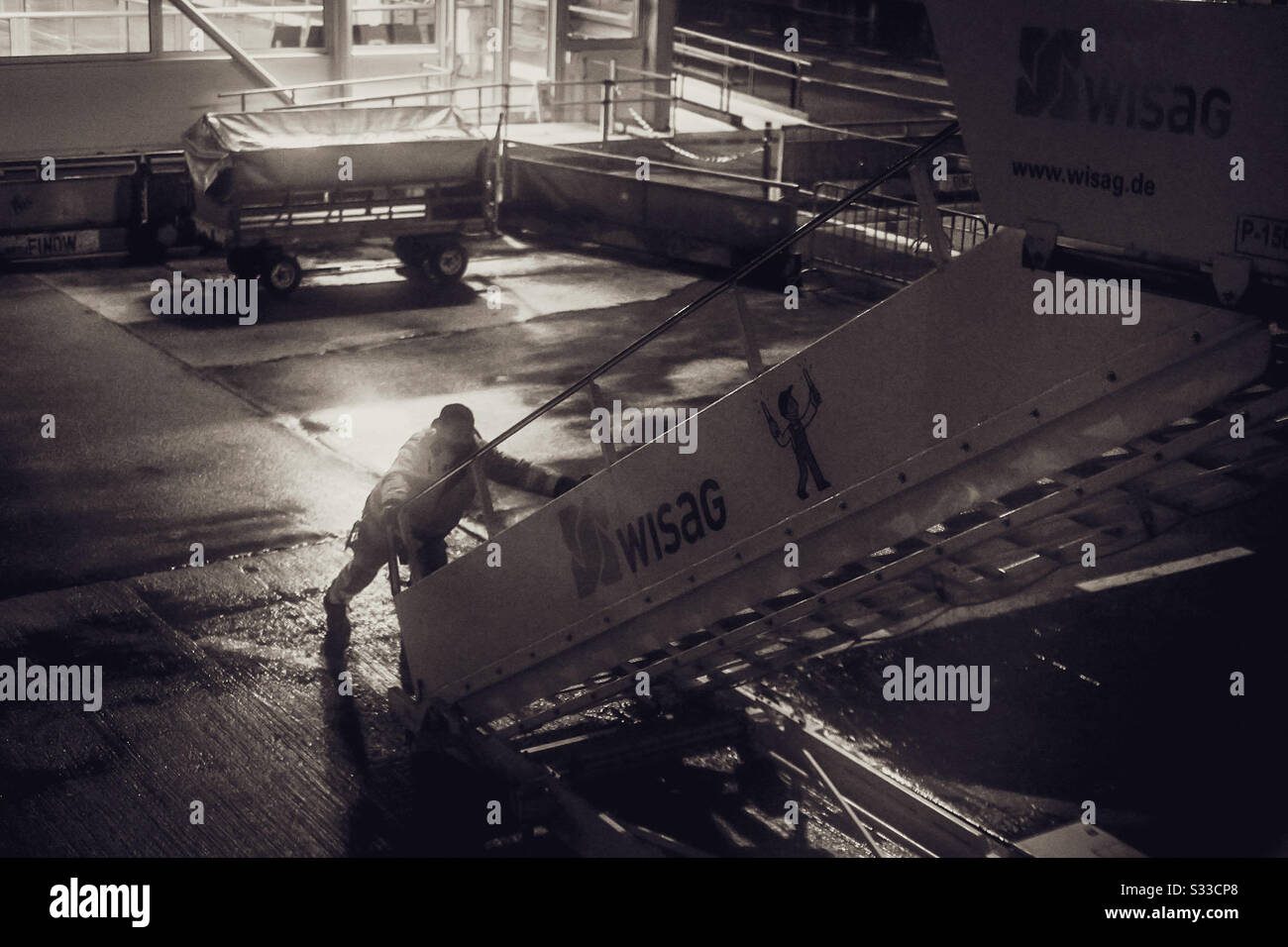 Steps are positioned on the door of an aircraft. Seem from the POV of a passenger on the aircraft - Smartphone Captured Stock Image