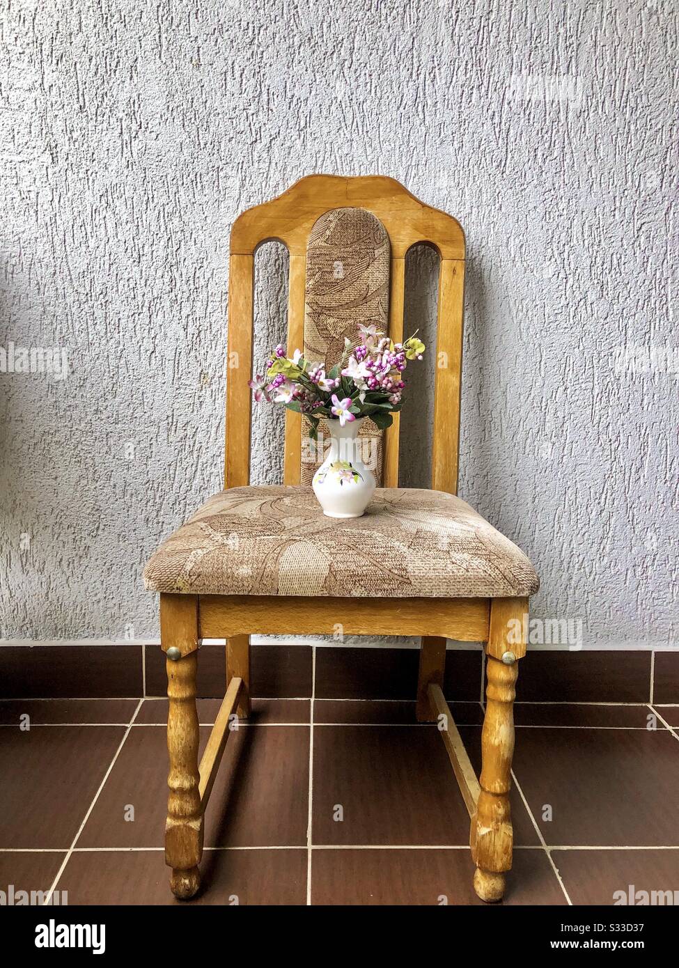 Vase with flowers on a wooden chair - Smartphone Captured Stock Image