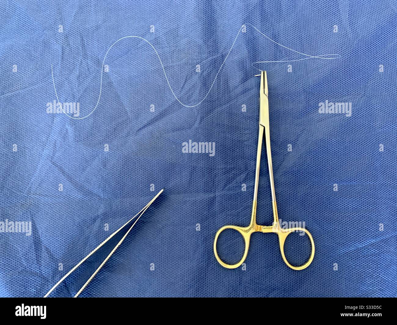 Surgical Instruments: Needle Holder, Adson Forceps  and Suture Needle. Stock Photo