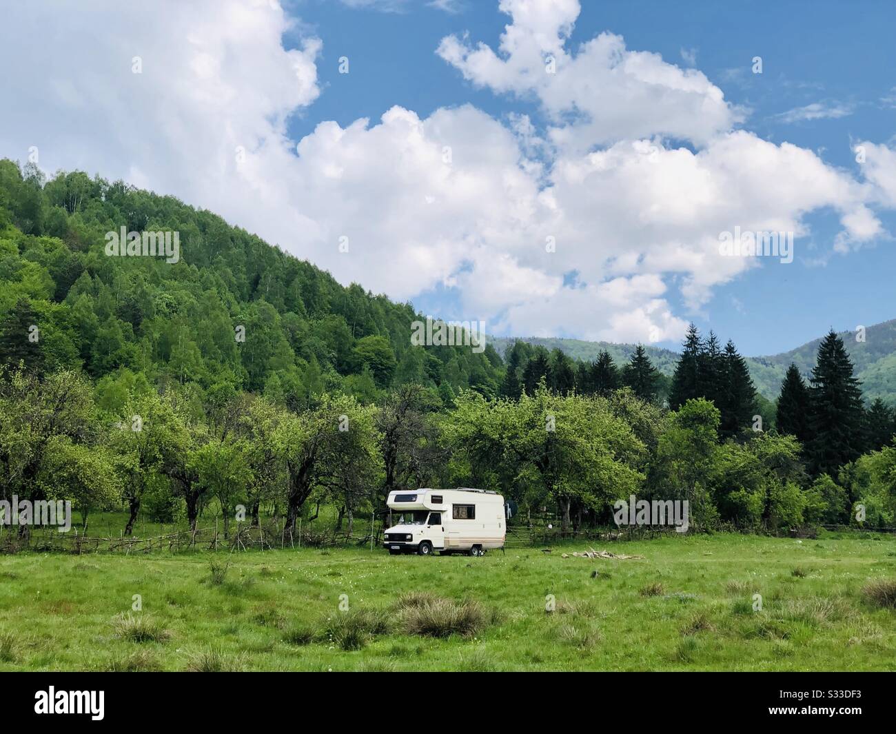 Camping van in a mountainous are on a sunny spring day - Smartphone Captured Stock Image