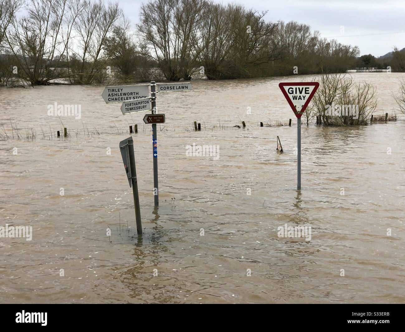 Flooding from Storm Dennis at Chaceley with road signs sticking out of the water. Stock Photo
