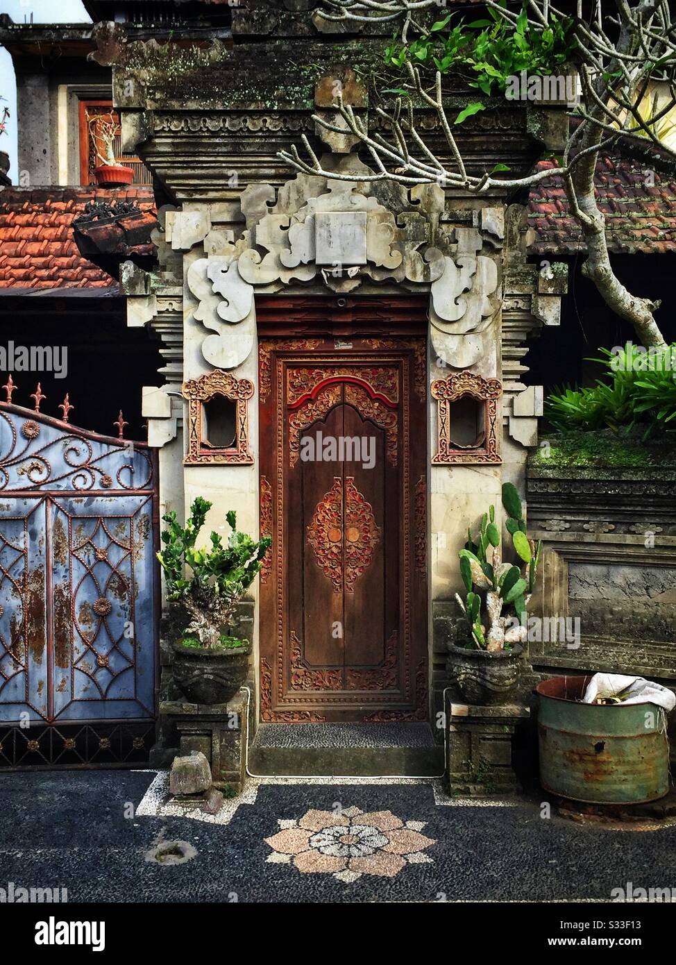 Ornate kori agung style gateway forms the entrance to a residential house near Ubud, Bali, Indonesia - Smartphone Captured Stock Image