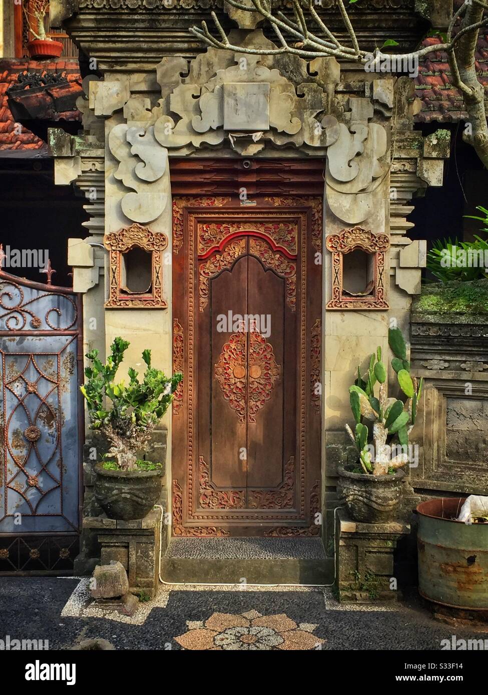 Ornate kori agung style gateway forms the entrance to a residential house near Ubud, Bali, Indonesia - Smartphone Captured Stock Image