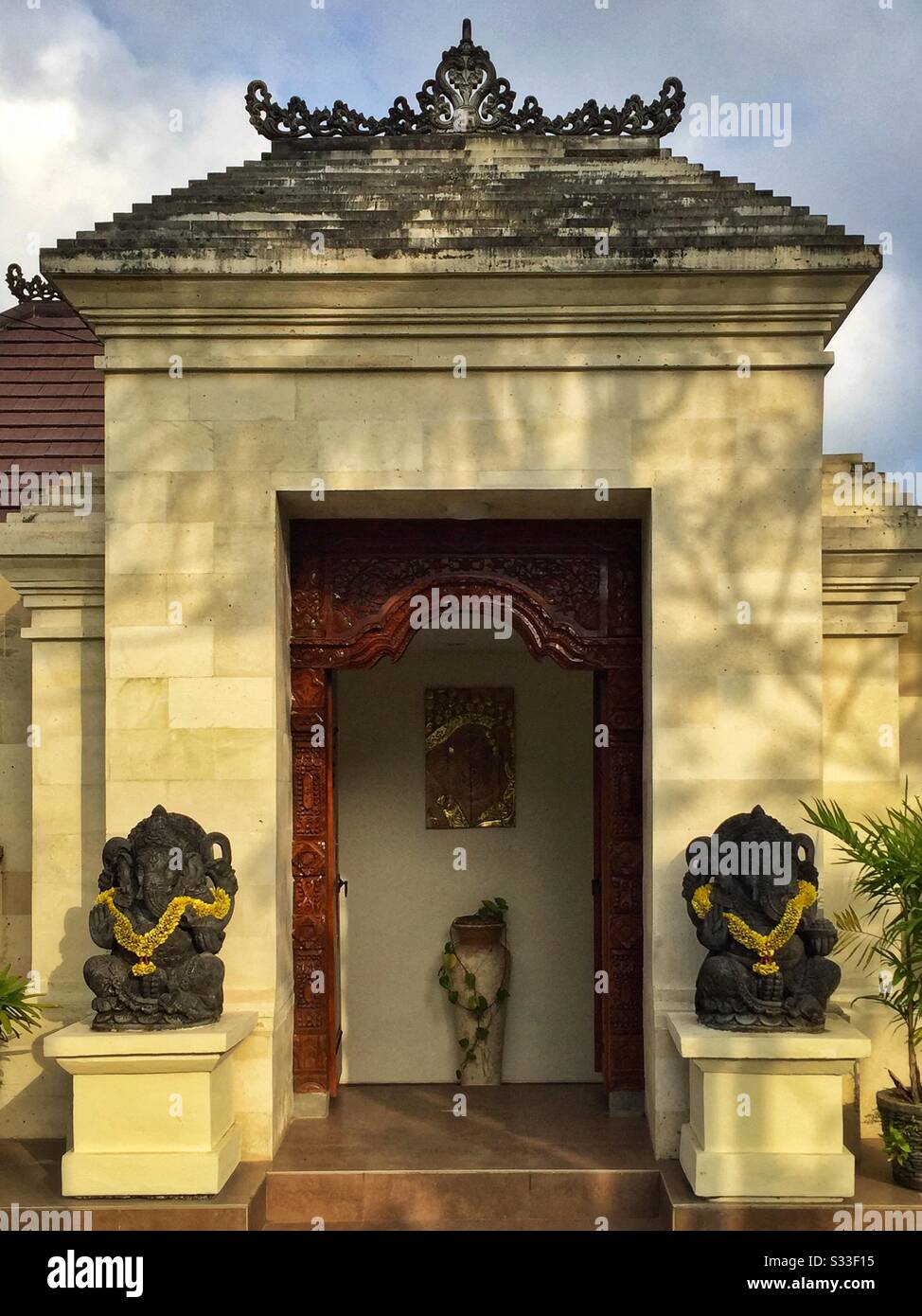 Ornate kori agung style gateway forms the entrance to a residential house near Ubud, Bali, Indonesia - Smartphone Captured Stock Image