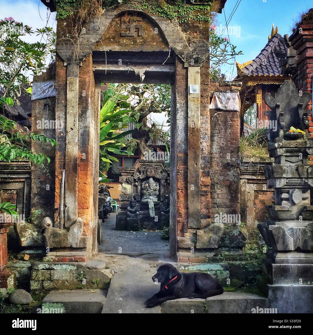 Ornate kori agung style gateway forms the entrance to a residential house near Ubud, Bali, Indonesia - Smartphone Captured Stock Image