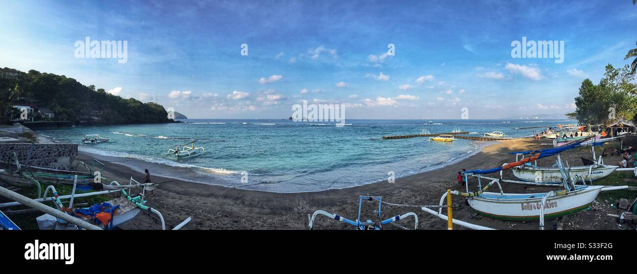 Traditional outrigger fishing boats on the beach at Candidasa, Bali, Indonesia - Smartphone Captured Stock Image