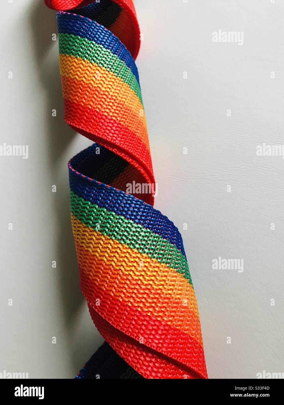 Close up view of colourful luggage belt , travel luggage belt - orange, green, blue, red, yellow colour belt reel Stock Photo