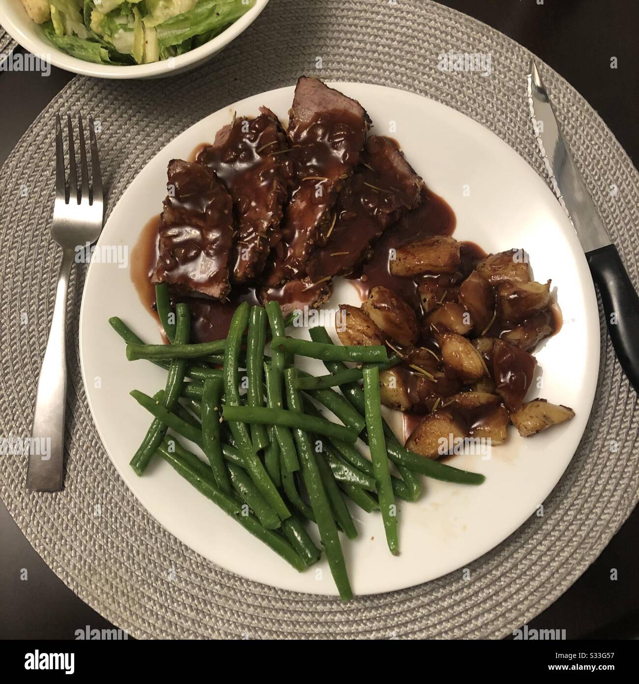 Horseradish Crusted Beef Striploin with green beans and roasted potatoes Stock Photo