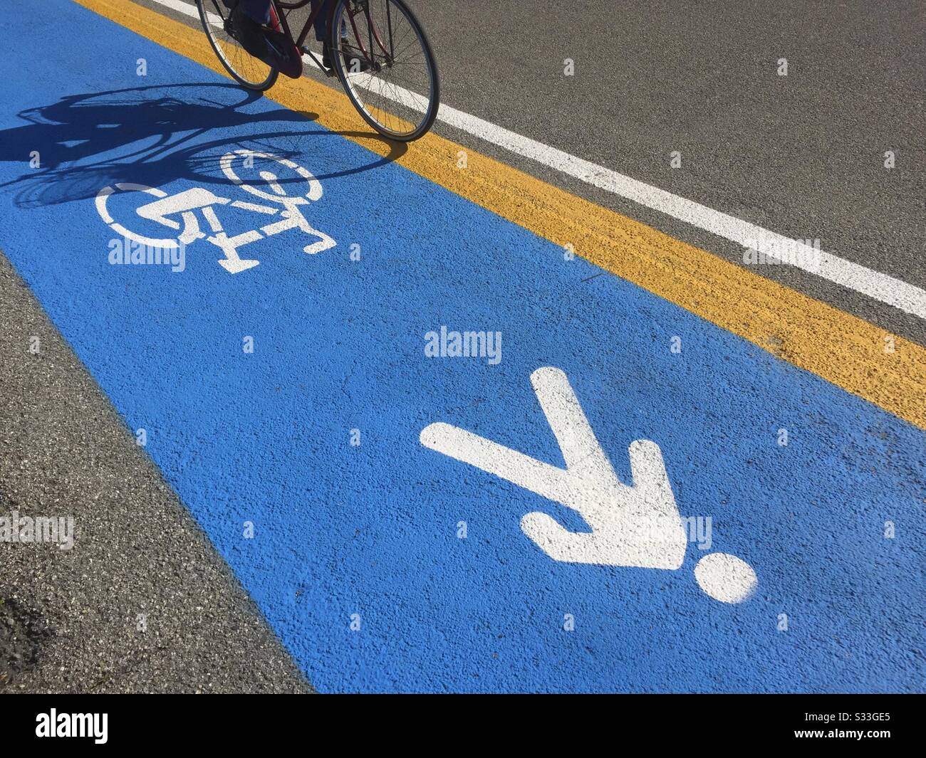 Italy, Lombardy, Cyclist on Bike Lane - Smartphone Captured Stock Image