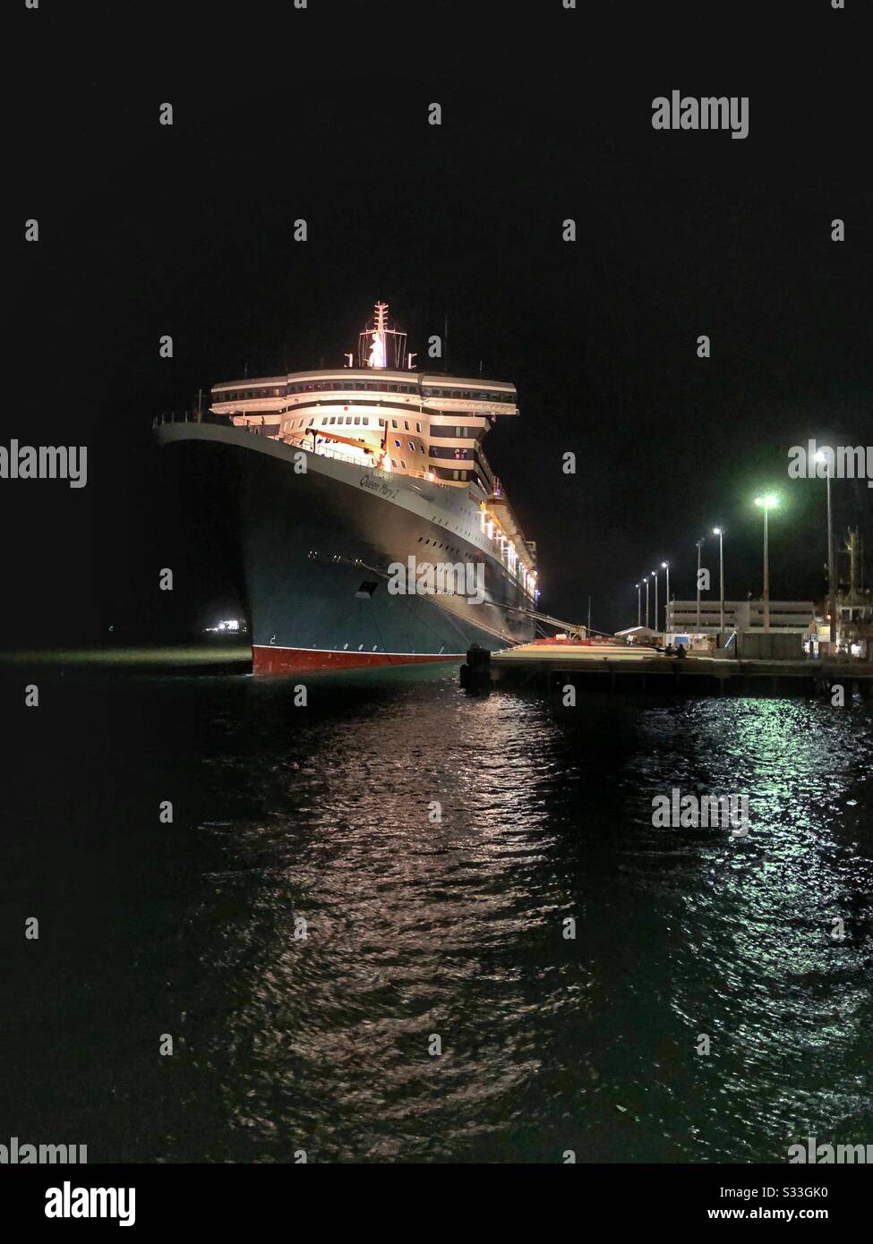 The Queen Mary 2 line cruiser ship, docked in Darwin, Northern Territory Australia at night. - Smartphone Captured Stock Image