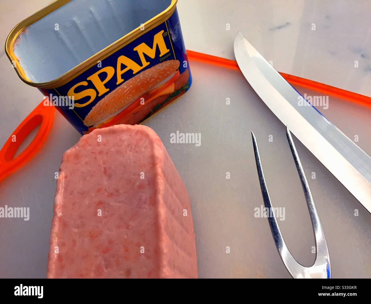 Freshly opened a can of Spam luncheon meat and carving set on a cutting board - Smartphone Captured Stock Image