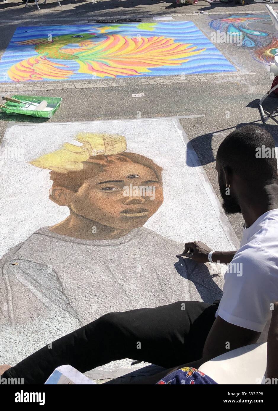 Sidewalk artist creating a portrait at the  Lake Worth Beach Art Festival in Florida. - Smartphone Captured Stock Image