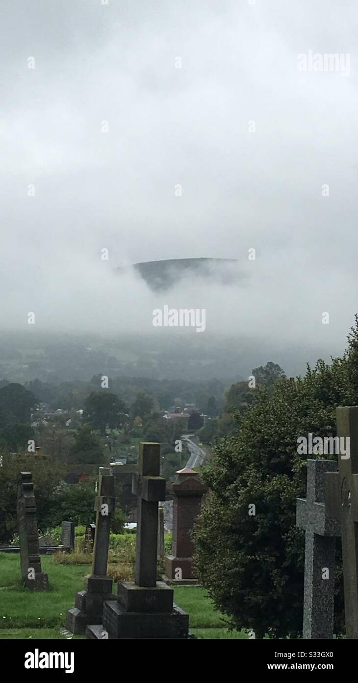 Foggy mountain over graveyard (Wales) Stock Photo