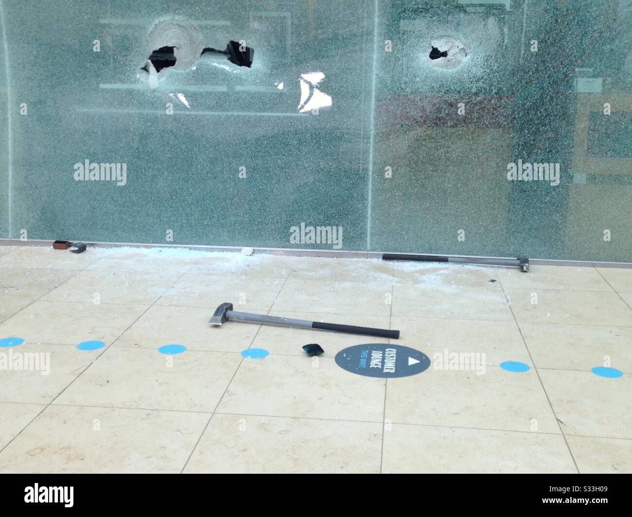 Basingstoke, UK- February 25, 2019: sledgehammers, broken glass and jewellery display boxes on th floor outside Beverbrook's jewellery shop in Festival Place basingstoke after a smash and grab robbery Stock Photo