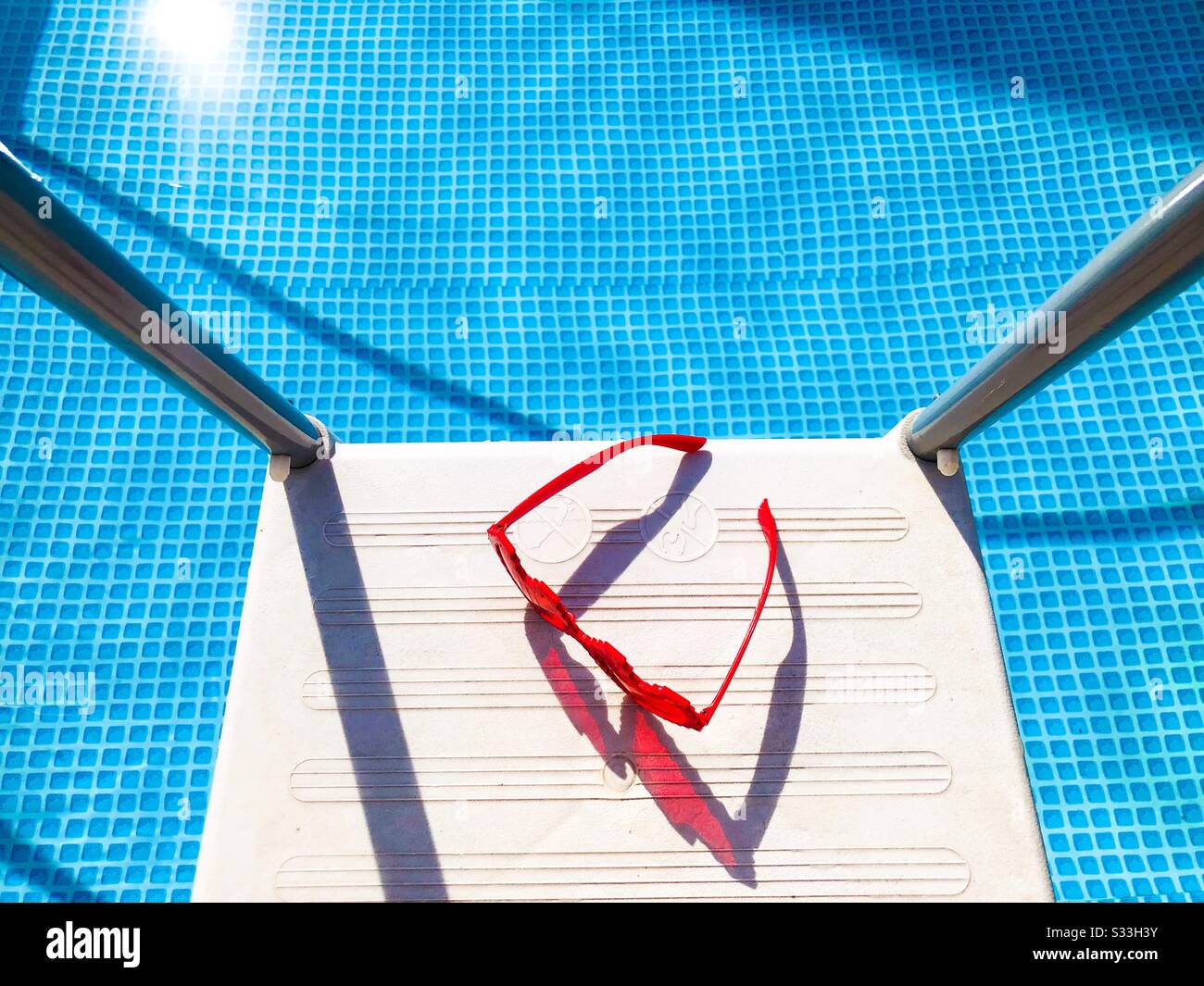 Heart shaped sunglasses by the poolside - Smartphone Captured Stock Image