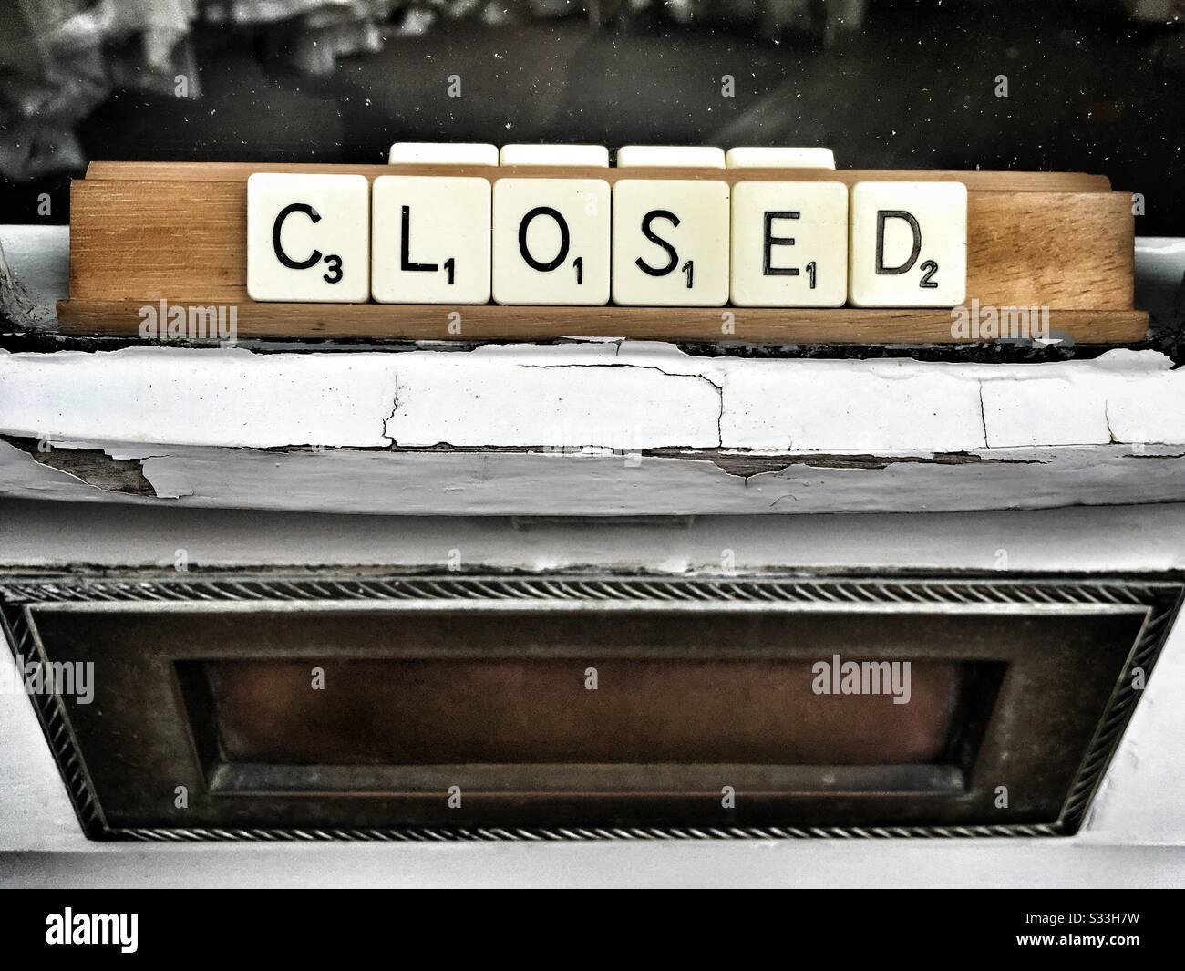 Closed sign in shop window made from scrabble letters - Smartphone Captured Stock Image