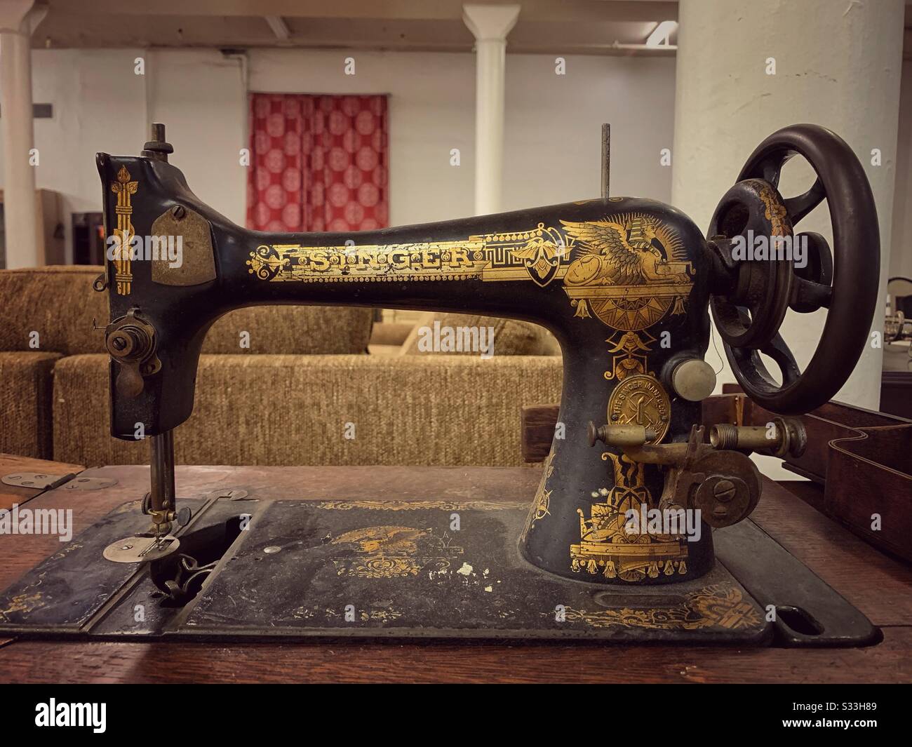 Vintage Singer hand cranked sewing machine with gold inlay logo and Egyptian decoration Stock Photo
