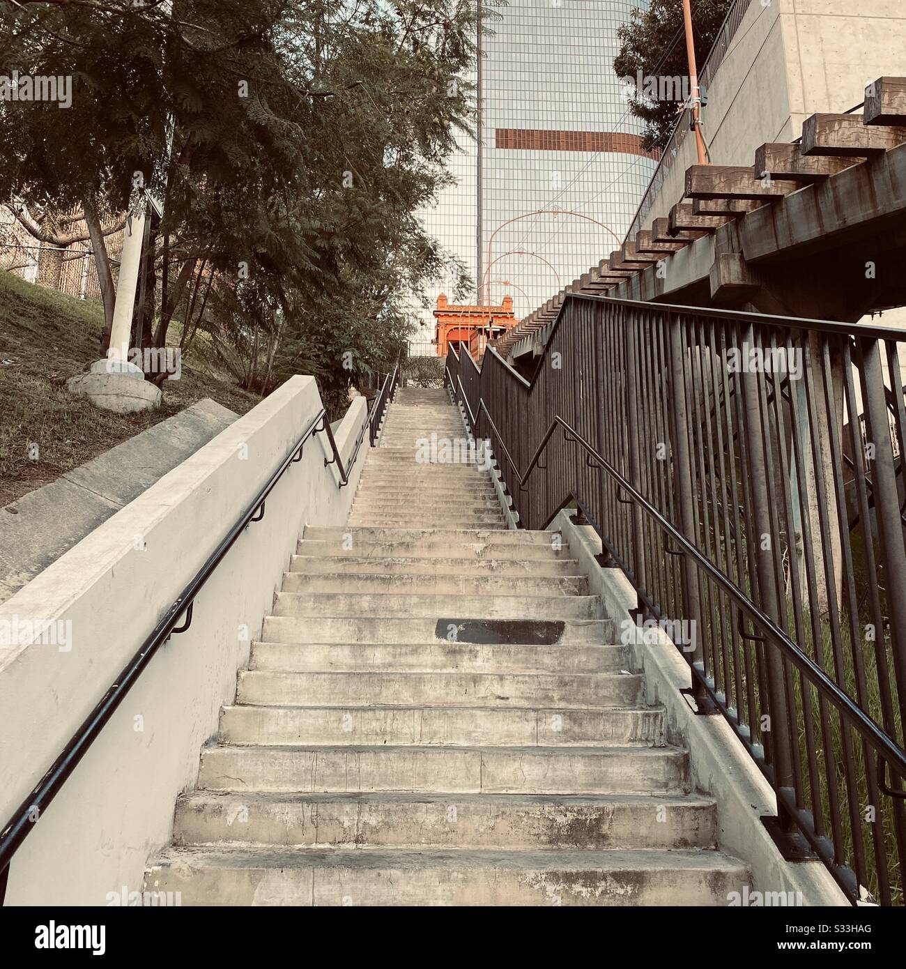 LOS ANGELES, CA, JAN 2020: concrete staircase next to Angels' Flight funicular railway in Downtown on overcast morning. Skyscrapers in background - Smartphone Captured Stock Image