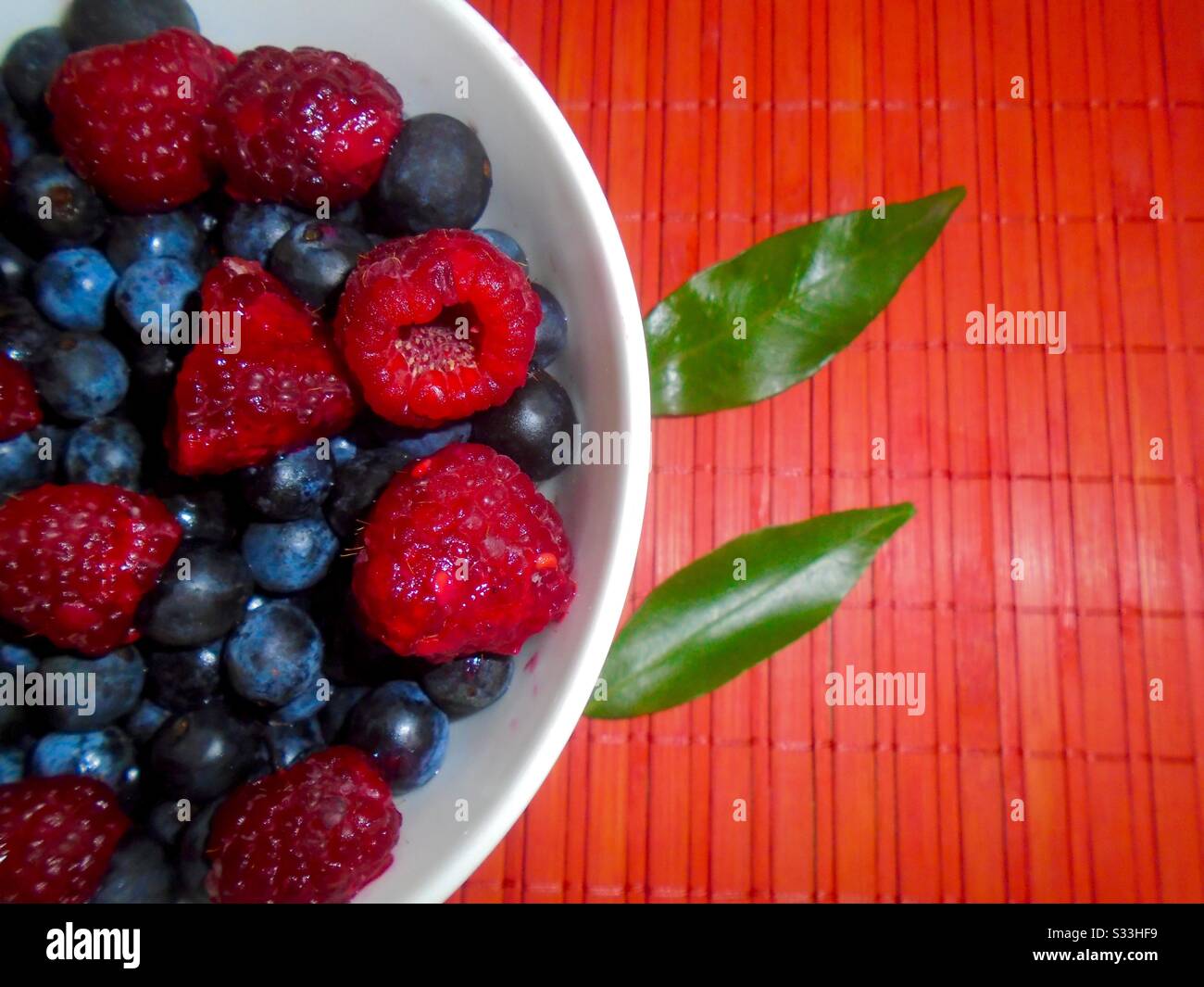 Bowl with blueberries and raspberries Stock Photo