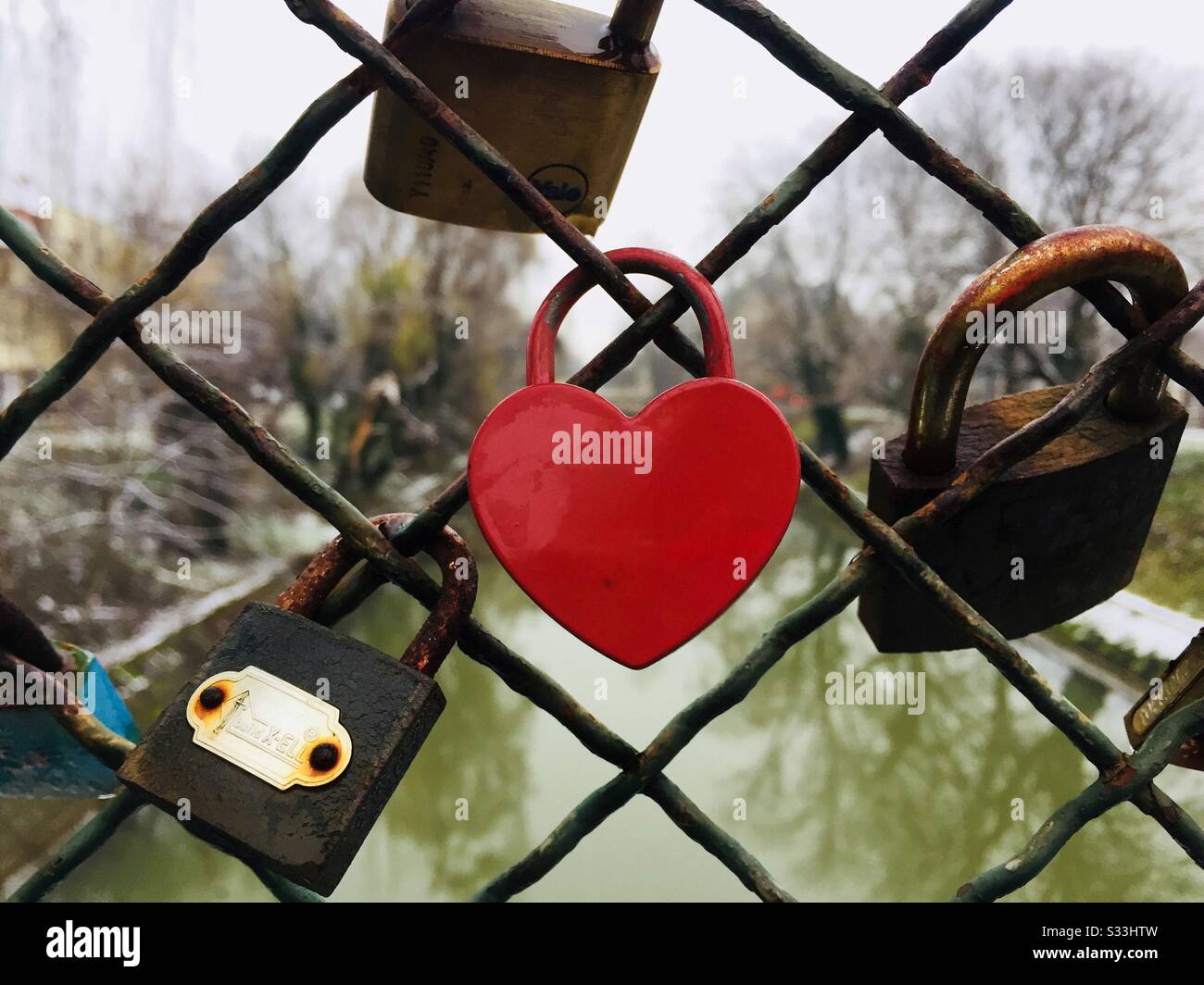 Heart shaped padloc hanging on a bridge - Smartphone Captured Stock Image