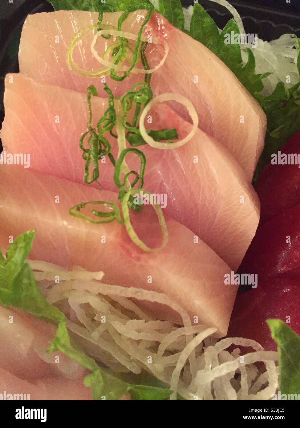 Flat lay of a Japanese entrée of fresh sashimi fish pieces Stock Photo