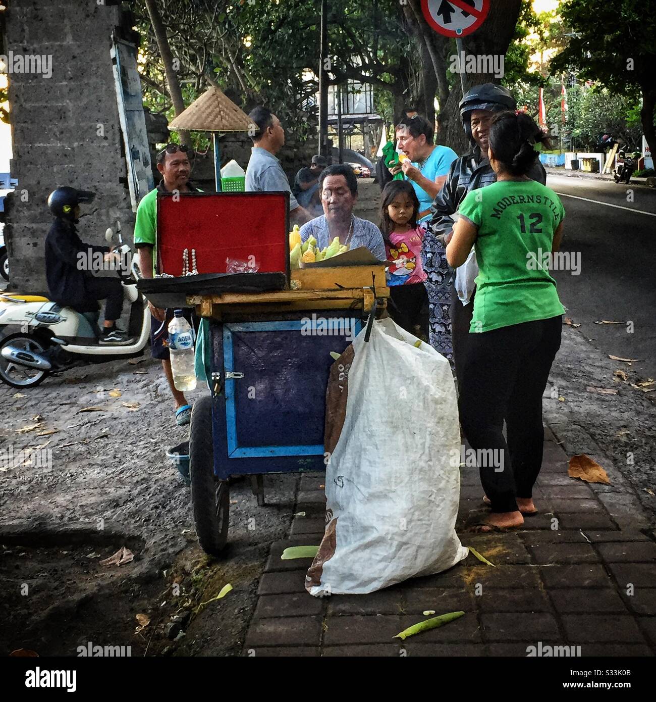 A street vendor sells barbecued corn cobs, Candidasa, Bali, Indonesia - Smartphone Captured Stock Image