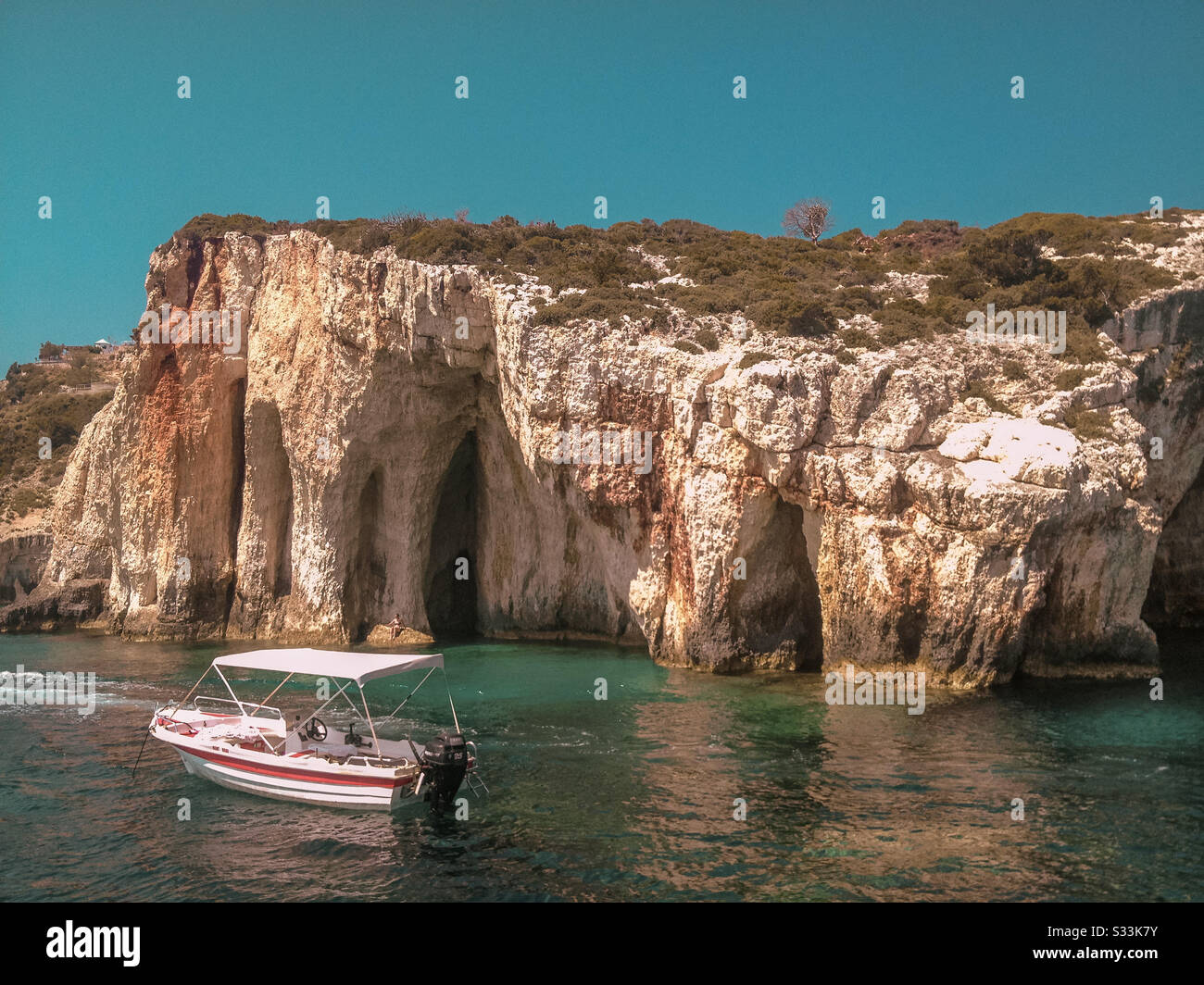 blue caves in Zakynthos, white boat at sea, vacation in Greece Stock Photo