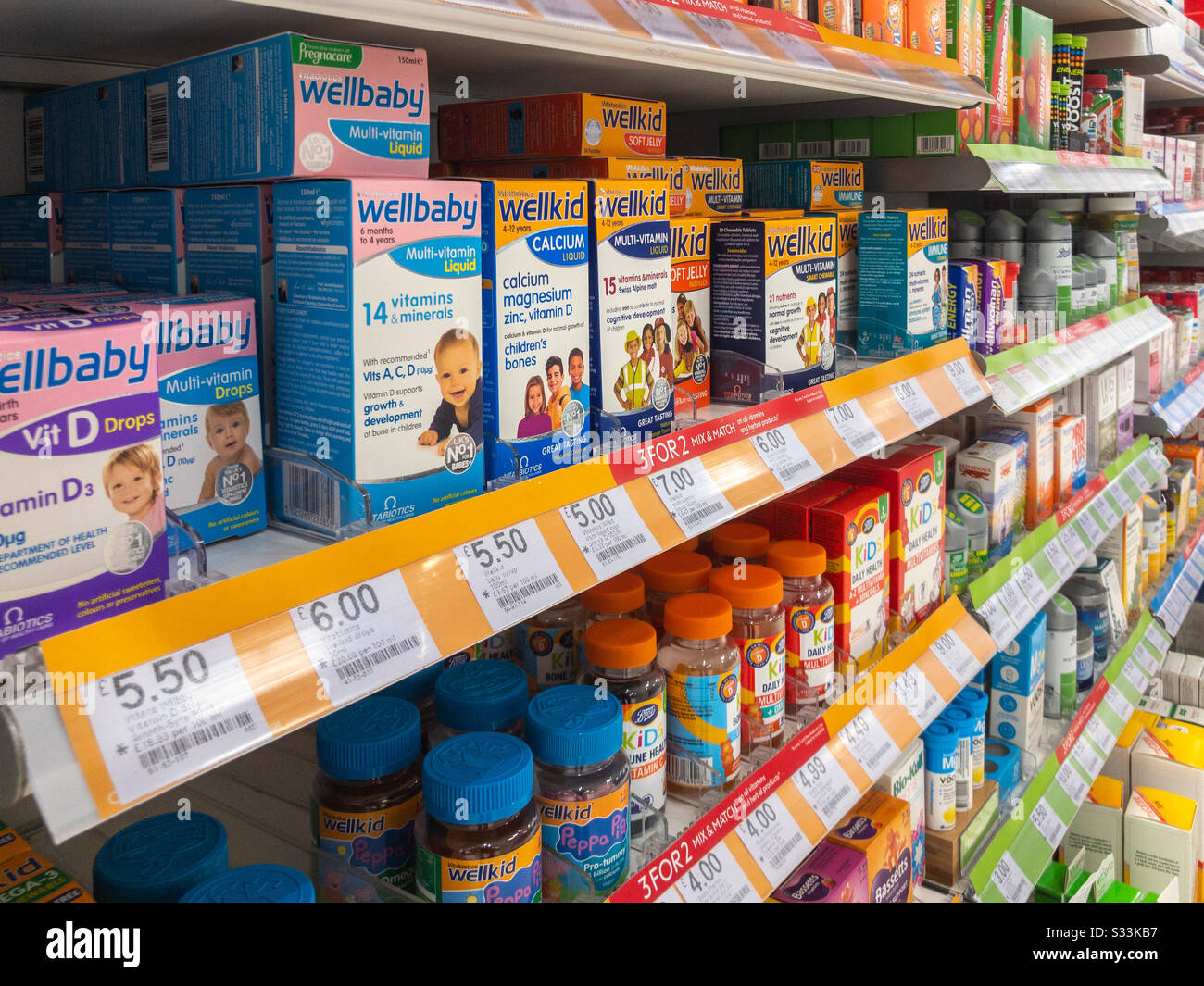 Children’s vitamins on sale and displayed on shelves in a shop. Stock Photo