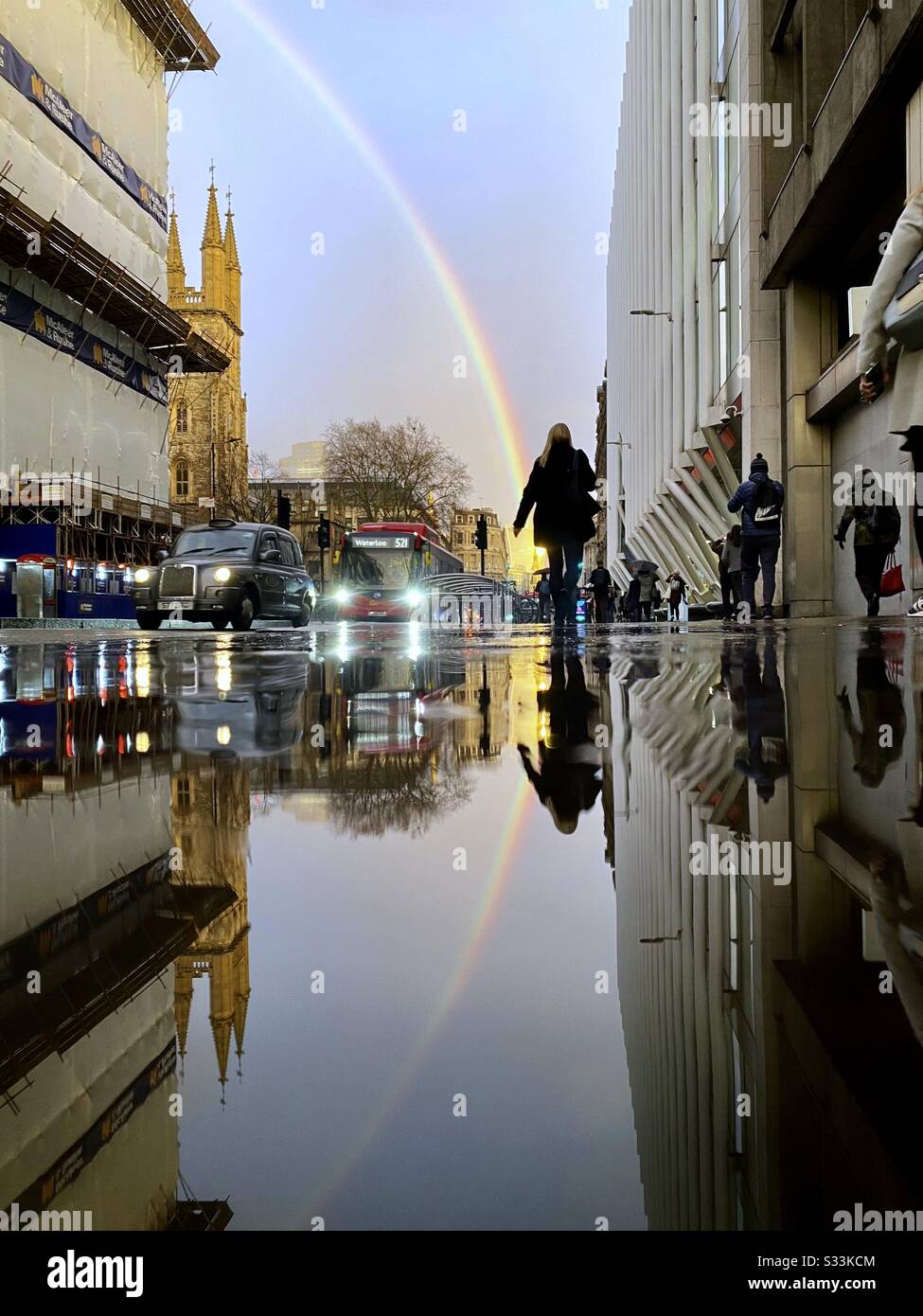 UK Weather: A rainbow shines over the Walkie Talkie building, as it is reflected on a rainy street in Holborn Viaduct, London, England. Stock Photo