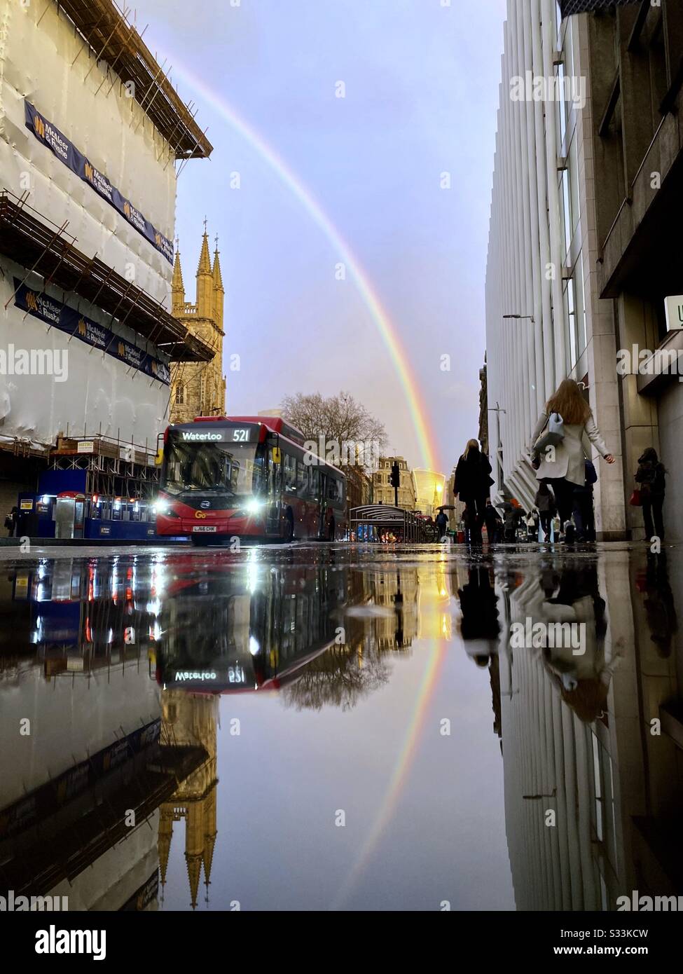 UK Weather: A rainbow shines over the Walkie Talkie building, as it is reflected on a rainy street in Holborn Viaduct, London, England. Stock Photo