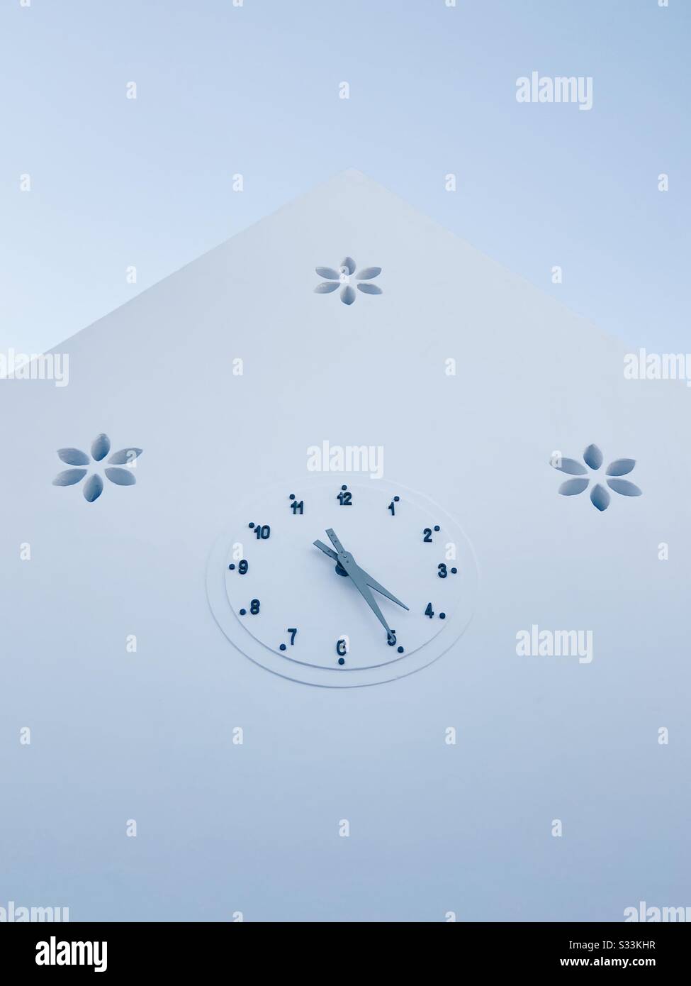 A clock on a white building reading 4:25pm, in Rosemary Beach, Florida, USA. - Smartphone Captured Stock Image