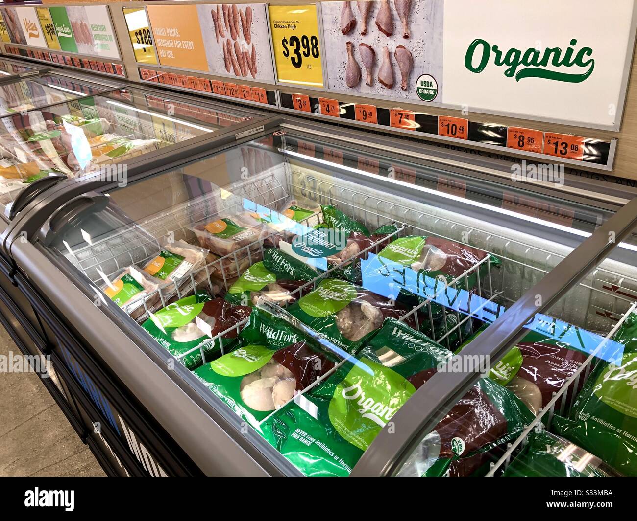 Display of frozen meats, seafood, and poultry at the organic market, The Wild Fork. Stock Photo