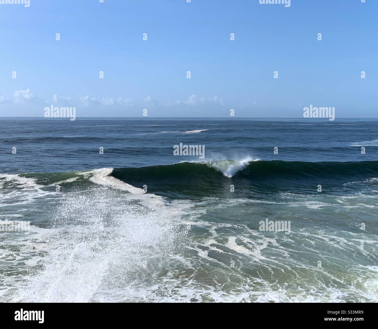 Wave breaking in a triangular shape - Smartphone Captured Stock Image