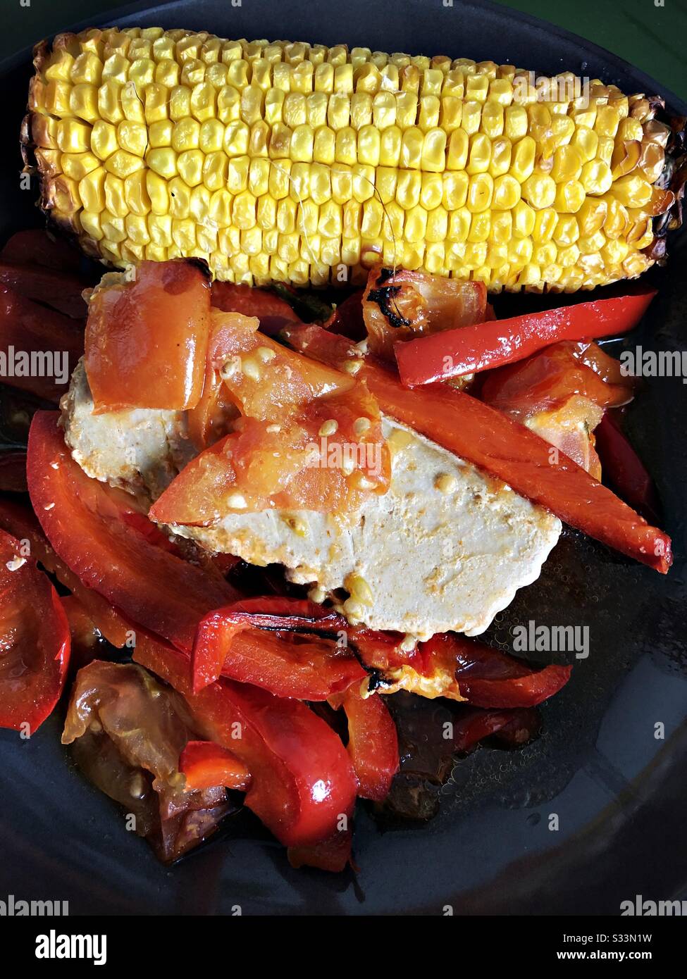 Tuna stake paprika and tomatoes sauce , served with sweetcorn - Smartphone Captured Stock Image