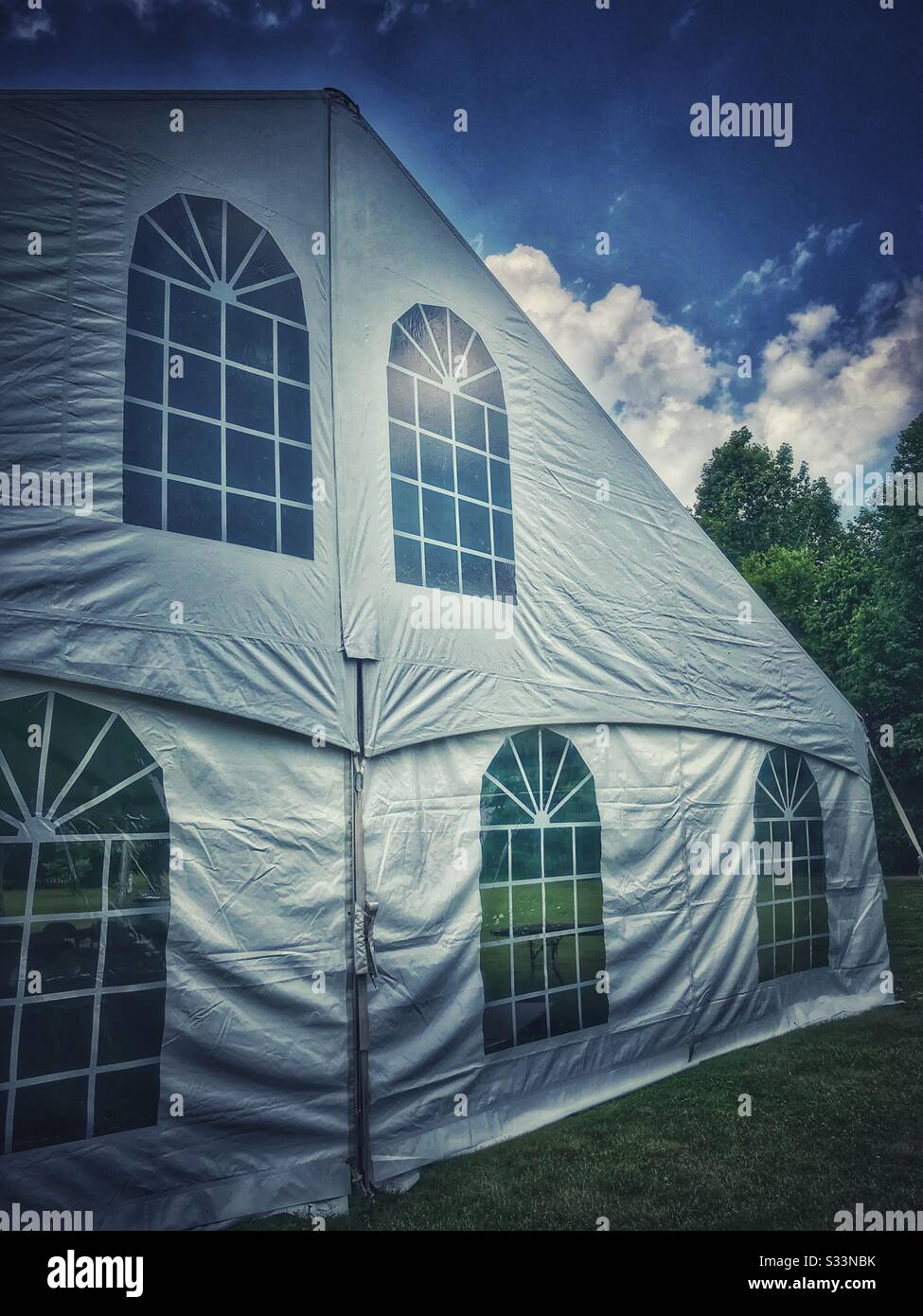 White event tent with blue sky and fair weather - Smartphone Captured Stock Image